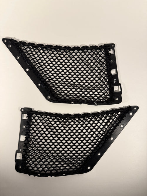 Two black mesh cargo net inserts with mounting clips, displayed against a plain, light background.